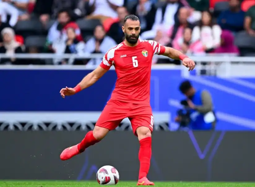 亞贊·阿拉布(Yazan Al-Arab)身穿約旦國家隊紅色球衣於場上控球準備傳球